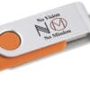 A close up of the top of an orange and white usb flash drive.